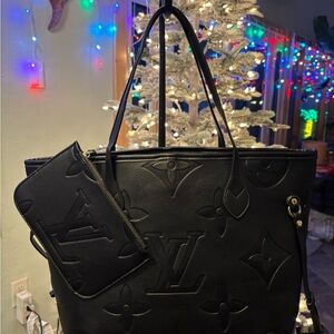 Louis Vuitton Neverfull MM tote in black Monogram Empreinte embossed with pouch